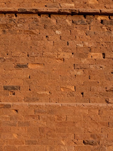 Terracotta clay walls of Bhatner Fort in Hanumangarh, warm golden-hour sunlight, detailed brick textures, 35mm photography
