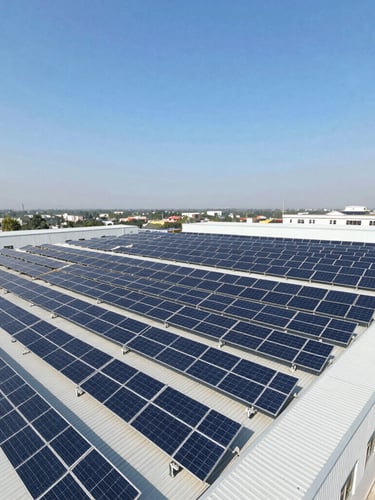 Wide-angle drone shot of a massive industrial solar array installed on a factory roof in Pakistan, bright direct sunlight, deep blue and metallic silver tones.