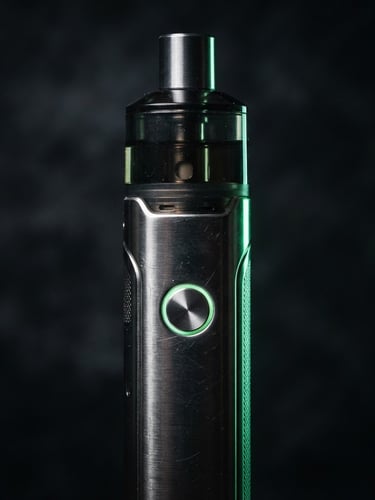 Sleek metallic vape hardware close-up, dark moody product photography, dramatic low-key studio lighting, neon green rim light, sharp macro details, 50mm
