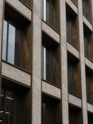 Architectural detail of a modern limestone and dark bronze corporate building facade in Mount Pleasant, soft overcast daylight, clean geometric lines, vertical framing.