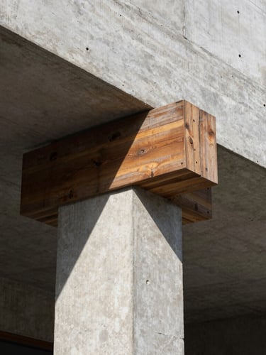 Low-angle architectural photography of a raw concrete structural column casting deep geometric shadows under harsh midday sun, weathered teak wood details, 35mm lens.