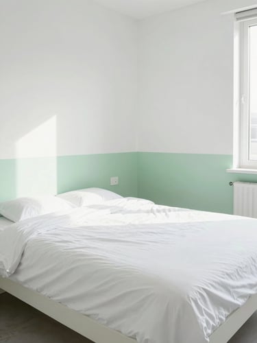 Straight-on architectural shot of a modern rental bedroom, perfectly made bed with crisp hospital corners, bright high-key natural daylight, clean white and soft green tones, sharp focus.