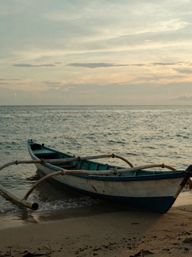 Atmospheric coastal photography of a traditional wooden fishing boat resting on the sandy shores of Kuala Batee, Aceh, during a golden-hour sunset, soft warm light reflecting off the water, 35mm.