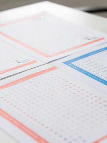 A close-up editorial photograph of physical assessment materials, colorful aptitude test sheets with vibrant coral and blue markings, modern desk setting, natural daylight, 35mm