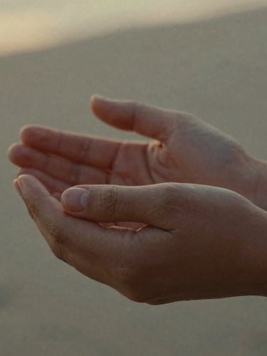 A close-up portrait of hands holding gently during a quiet moment, soft golden-hour natural light, muted earth tones, cinematic 35mm film grain, shallow depth of field.