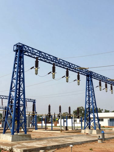 Wide-angle architectural shot of a newly commissioned high-voltage electrical substation in Nigeria, crisp daylight, royal blue structural steel, sharp focus, 35mm