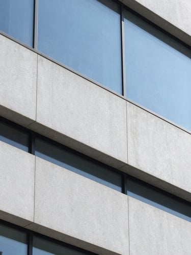Close-up of a clean architectural surface in a modern corporate office, bright natural daylight, sharp focus
