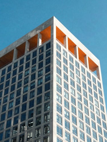 Sharp architectural angle of a modern concrete and glass skyscraper in Miami under high-key natural daylight, crisp shadows, electric blue sky