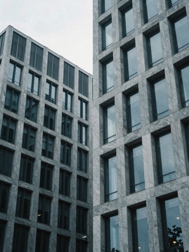 Abstract architectural lines of a modern corporate building, sharp geometric shadows, cool overcast daylight, desaturated blue and slate tones, 35mm lens