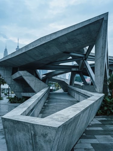 Architectural detail of a modern civic pavilion in Kuala Lumpur, sharp concrete angles, cool morning overcast light, desaturated blue tones, 35mm lens