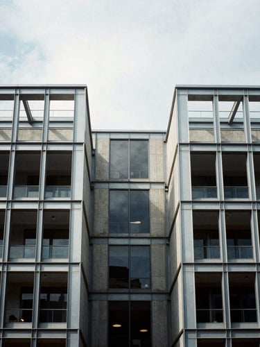 Symmetrical architectural detail of a modern steel and concrete commercial building under a crisp overcast sky, high contrast shadows, 35mm architectural film photography style