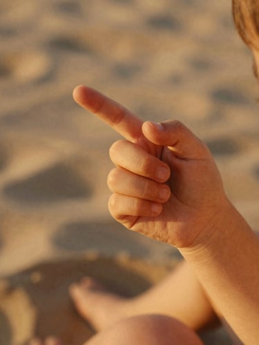 Intimate close-up of a child's hand holding their mother's finger, warm golden hour sunlight filtering through, shallow depth of field, cinematic film photography.
