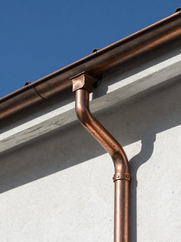 Extreme close-up of copper roof flashing meeting a pristine white stone wall, sharp shadows, bright Swiss daylight, architectural photography