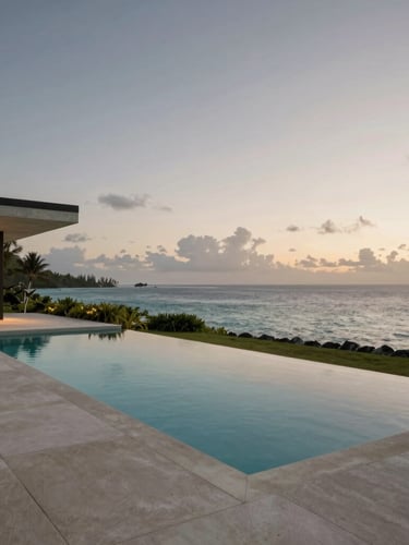 Wide architectural study of a minimalist concrete villa pool deck at twilight, overlooking a calm ocean in Bora Bora, warm soft lighting, generous negative space