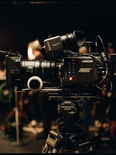 Cinematic film photography, dramatic low-key lighting, anamorphic lens close-up of a high-end cinema camera on a professional commercial studio set, rich moody tones, shallow depth of field
