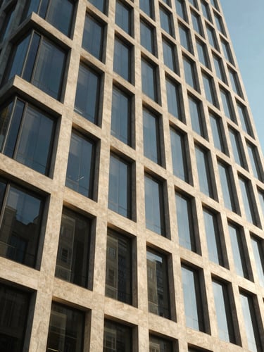 Wide-angle editorial corporate photography of a modern concrete and glass skyscraper facade, sharp architectural daylight, clean geometric lines, 35mm