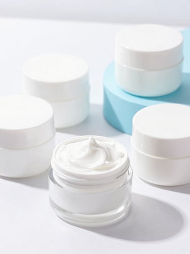 Bright high-key commercial photography of neatly arranged cosmetic containers on clean white and soft blue surfaces, sharp focus