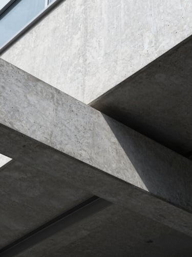 Macro detail shot of architectural concrete lines and steel beams, cool diffused daylight, sharp clean shadows, minimalist corporate geometry.