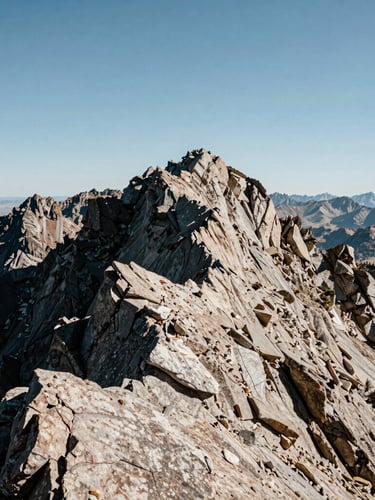 Wide-angle daylight shot of rugged Wasatch mountain peaks in Utah, sharp rocky textures in the foreground, off-center framing with negative space on the left, crisp natural lighting.