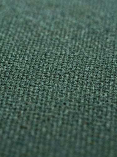 Macro close-up of high-quality organic cotton textile fibers under clinical laboratory lighting, showing intricate woven texture and clean structure, sharp focus