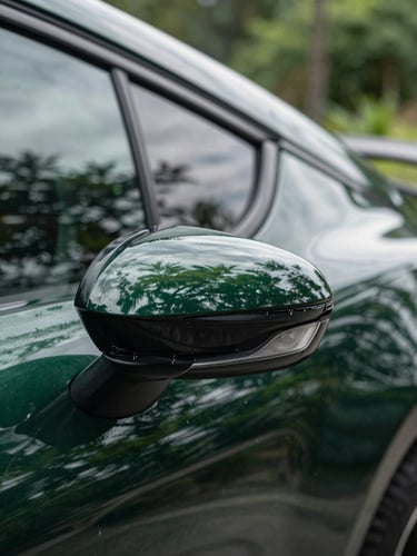 Extreme macro of a clean car panel reflecting green foliage under natural overcast daylight, high-contrast gloss finish, 50mm lens