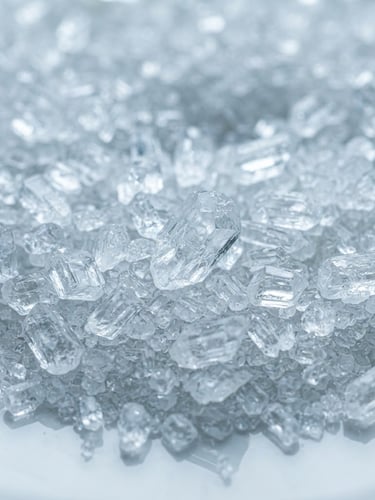 Macro close-up of crystalline Monosodium Phosphate (MSP) powder, sharp focus on individual translucent crystals, bright white laboratory light, cool blue and white tones, 50mm lens, industrial precision.