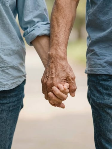Warm editorial photograph of a driver gently holding an elderly passenger's hand as they walk, soft natural daylight, shallow depth of field.