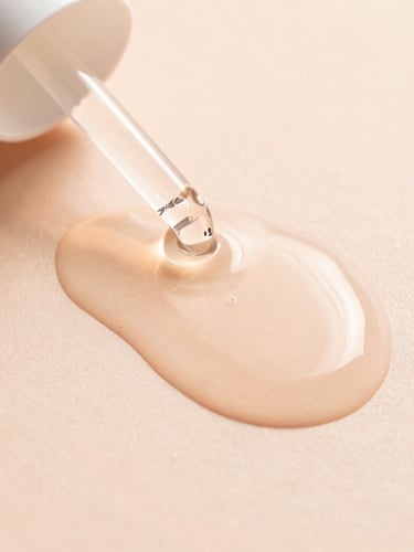 Macro shot of liquid serum texture flowing on a smooth surface, soft morning sunlight, peach tones, dewy finish, minimalist aesthetic, 35mm