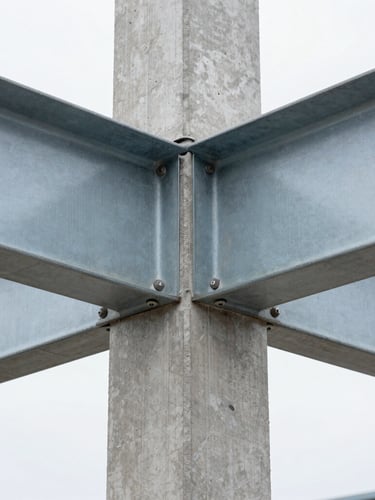 Extreme close-up of a structural steel connection bolted to raw concrete, natural overcast daylight, sharp focus, 35mm lens.