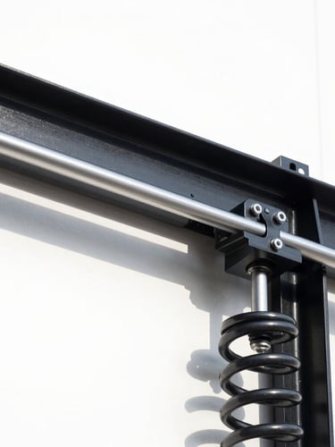 Close-up architectural shot of a modern black steel garage door track and pristine heavy-duty torsion spring, crisp technical daylight, high contrast