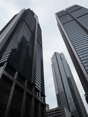 Low-angle architectural shot of Jakarta's financial district skyscrapers intersecting against an overcast sky, high contrast, stark geometry.