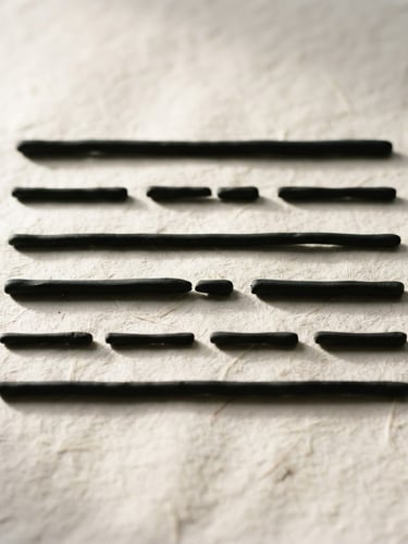 Minimalist composition of six sculptural black horizontal lines, some solid and some broken, arranged on a textured off-white paper background, soft side lighting, high contrast, atmospheric fine art photography.