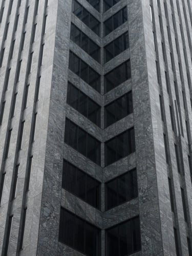 Abstract architectural lines of a modern corporate skyscraper in São Paulo, cool slate tones, sharp angles, natural daylight.