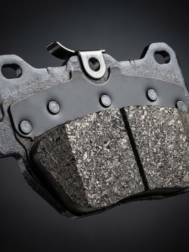Macro close-up of a pristine metallic brake pad, studio strobe lighting, high-contrast dark grey background, sharp metallic textures, macro lens