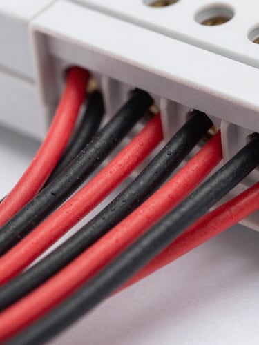 Macro shot of a neatly wired modern consumer unit with clean red and black wires perfectly organized, high contrast, sharp details, 35mm