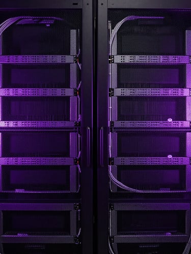 Symmetrical, low-key dramatic studio shot of enterprise server racks, cool-toned violet rim lighting, clean cable management, sharp technical focus.