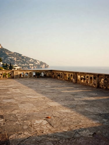 Wide environmental shot of an empty, sun-drenched stone terrace overlooking the Amalfi Coast at golden hour, no people, soft shadows, 35mm