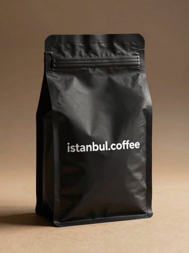 Minimalist mockup of the domain name istanbul.coffee printed on a high-end matte black coffee bag, warm side lighting, rich shadows, elegant editorial setting