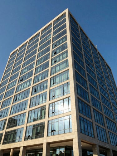 Wide-angle architectural shot of a modern corporate office building in Dakar, clean glass facade reflecting bright West African sunlight, deep blue sky, professional corporate aesthetic