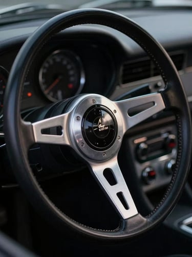 Macro close-up of a vintage steering wheel and polished silver dashboard of a classic sports car, moody studio lighting, deep shadows