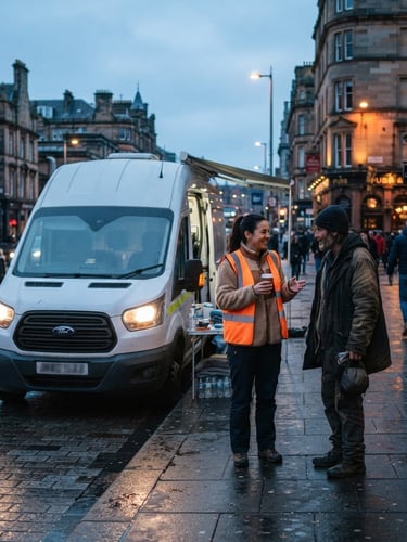 Wide shot of the REACH mobile outreach van parked on a city street at dusk, headlights on, with a volunteer in a high-visibility vest standing beside it, engaging with someone respectfully. Natural street lighting, cool blue tones.