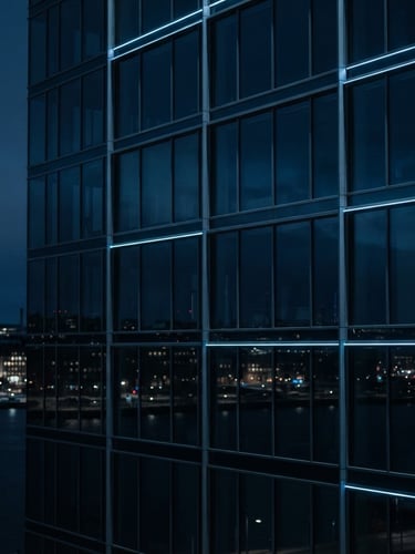 Sleek architectural crop of Stockholm modern glass facade reflecting low-key cool blue ambient light, minimalist composition, 35mm lens