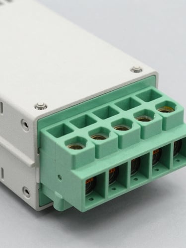 High-resolution macro shot of a variable frequency drive terminal block, clean gray background, bright studio lighting, sharp technical details