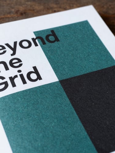 Editorial book photography of the 'Beyond the Grid' cover, bold minimalist geometric design, deep teal and rich black tones, soft side-lighting, 3:4 portrait crop