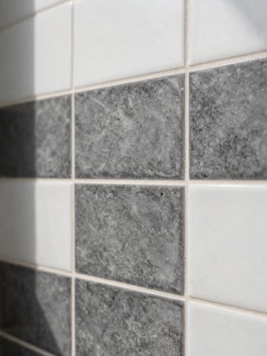 Sharp architectural photography, bright natural daylight, high-contrast charcoal and white tones, crisp focus, 35mm. Extreme close-up of zero-tolerance tile alignment in a modern bathroom remodel.