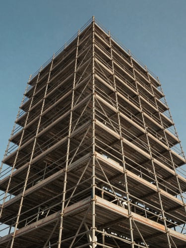 Low-angle industrial shot looking up at a massive, perfectly aligned structural scaffolding system against a clear blue Abu Dhabi sky, highlighting metallic joints and safety rails.
