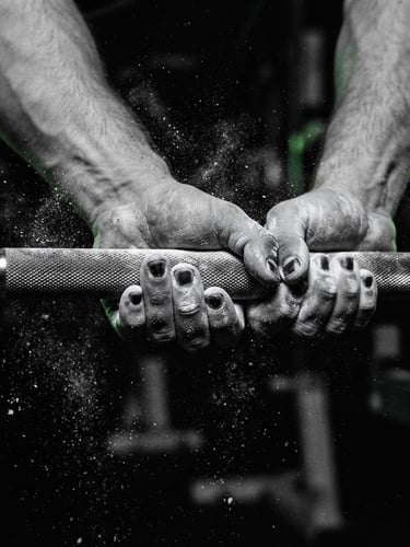 Dramatic close-up of hands gripping a steel barbell, chalk dust in the air, high-contrast black and white photography with sharp green lighting highlights, 35mm