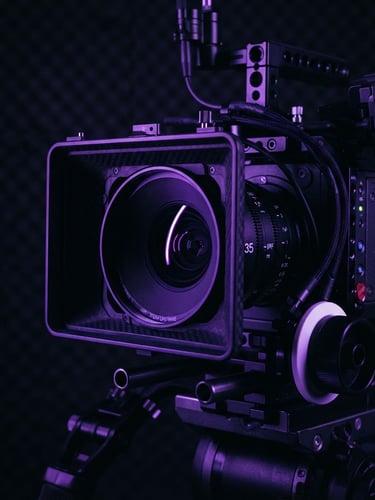 Extreme close-up of a professional cinema camera rig in a dark studio, sharp electric violet rim lighting reflecting on the lens, high-tech nocturnal atmosphere, 35mm lens focus.