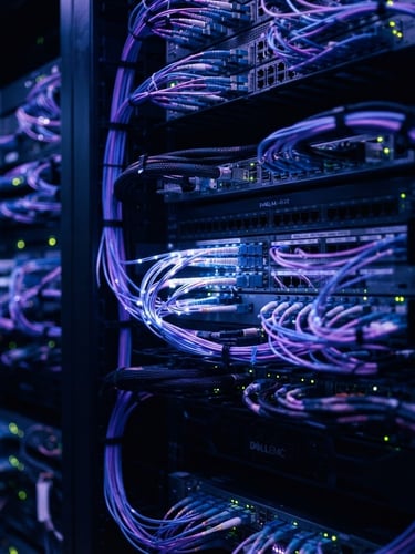 Cinematic macro shot of high-end server racks with deep violet and cool blue ambient glows, shallow depth of field, sharp focus on glowing fiber optic cables.