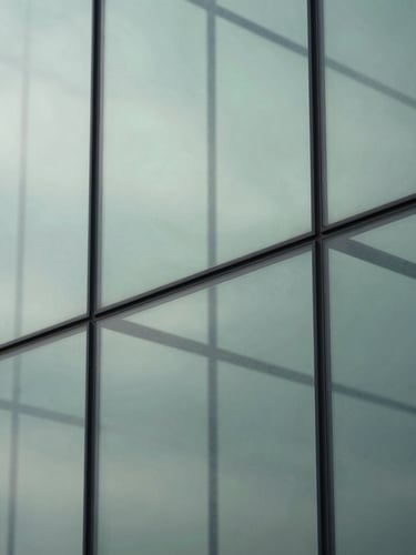 Abstract representation of mental clarity, structured geometric glass elements reflecting soft overcast daylight, cool clean tones with subtle sage green highlights, minimalist composition, 35mm lens